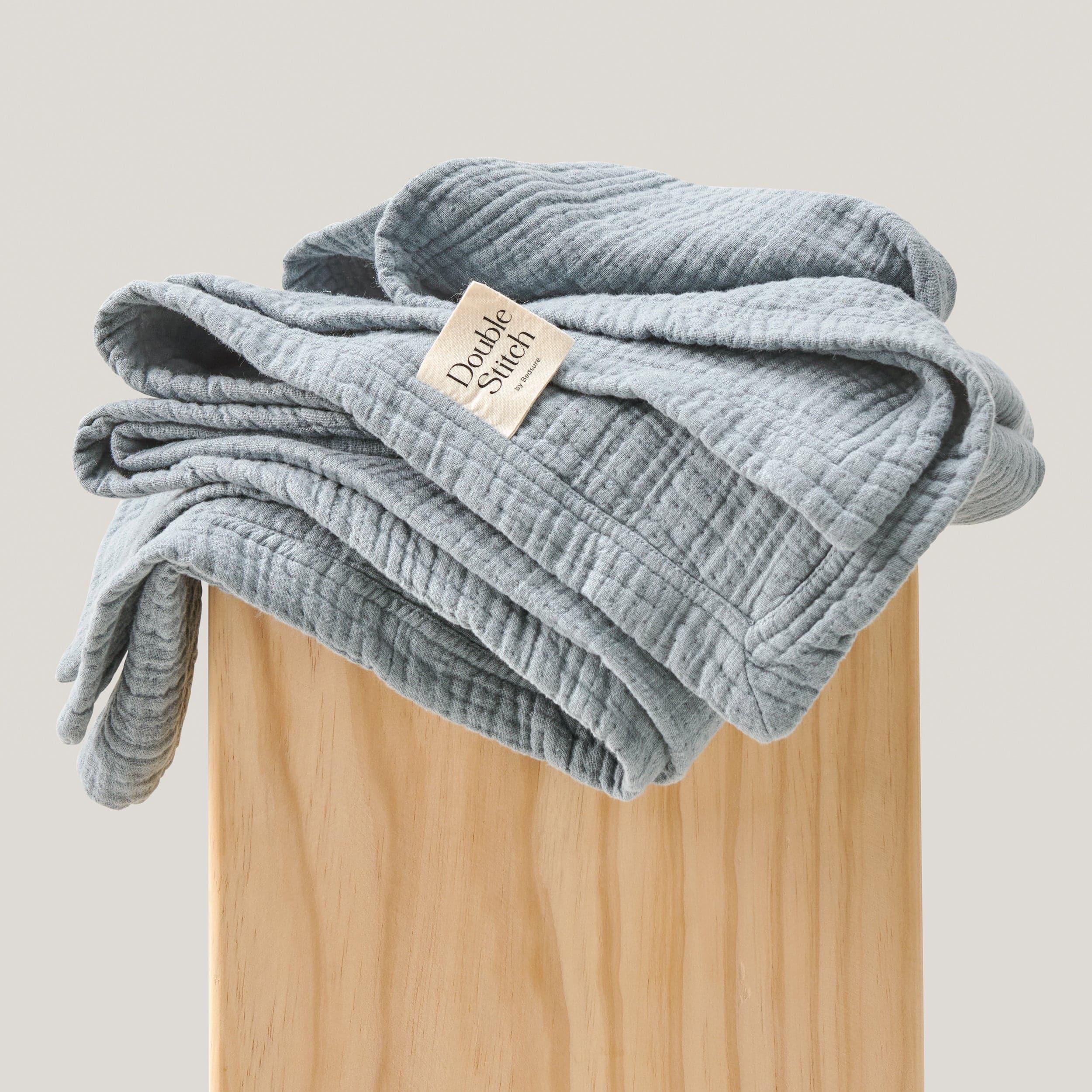 The soft texture of the knit throw blanket makes it perfect for cuddling up with a good book.