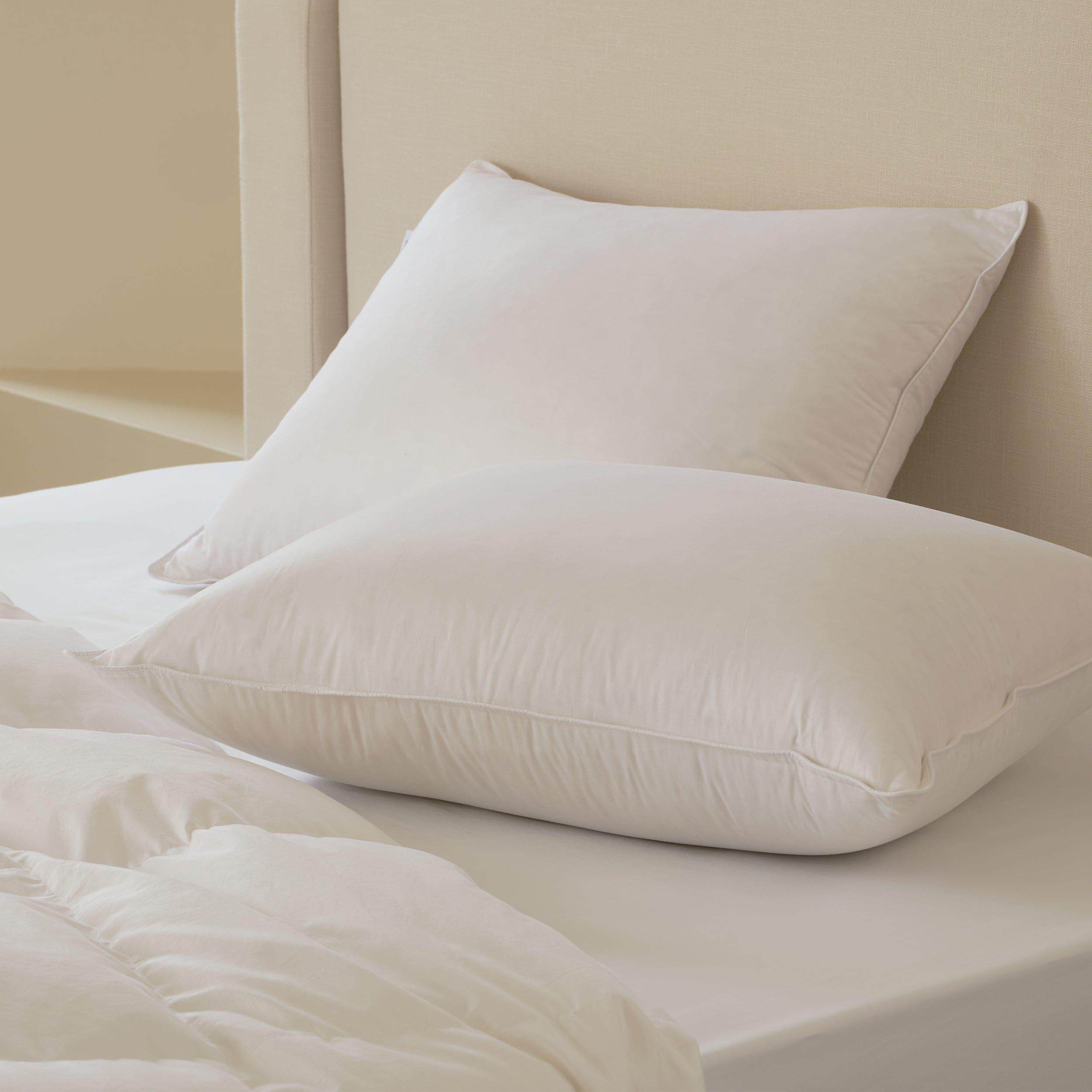 The down pillow is encased in a soft and breathable fabric, enhancing its comfort and durability.