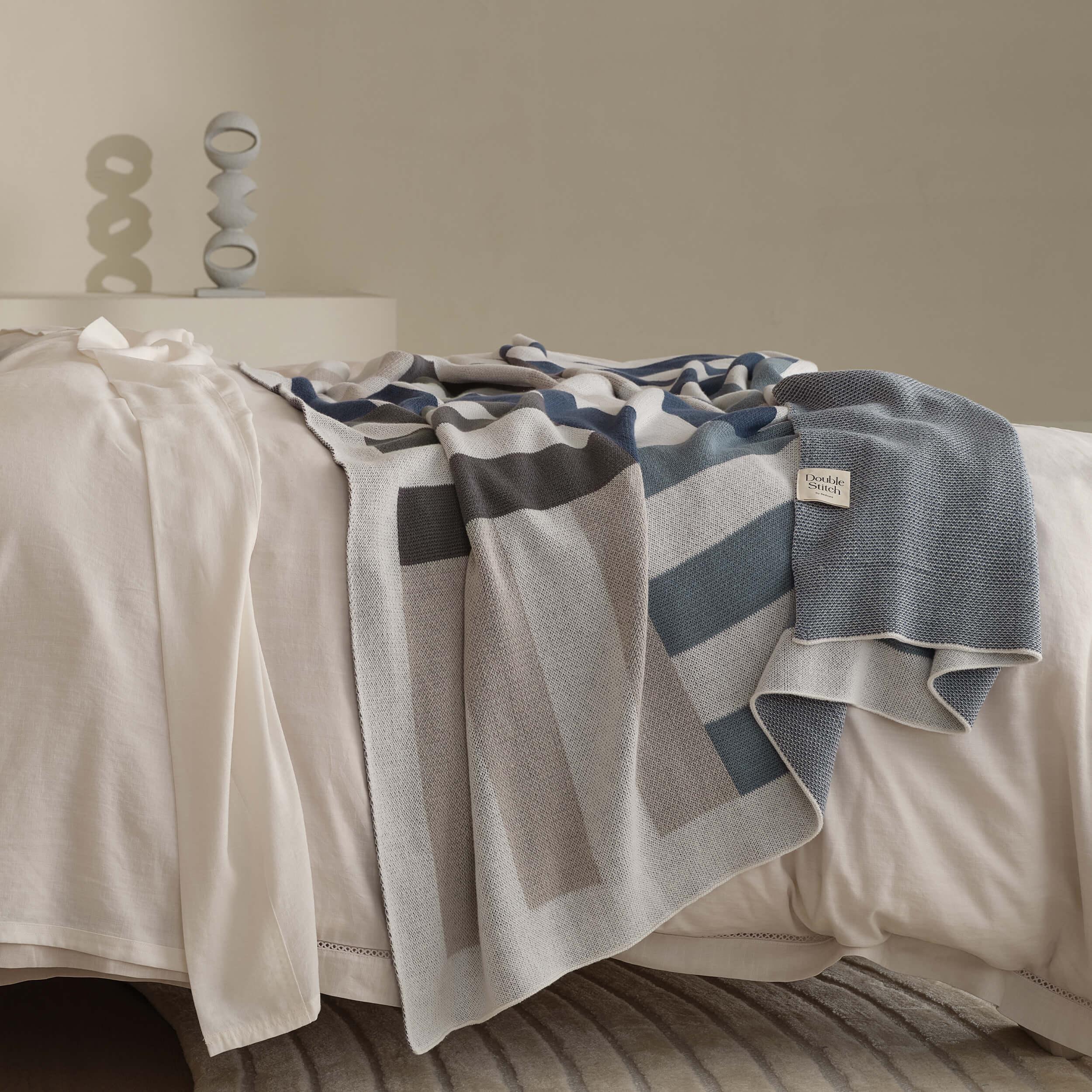 The Intarsia knit pattern on this modern throw blanket creates a captivating visual effect.